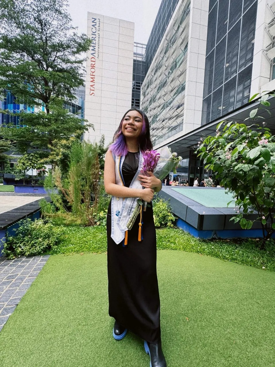 Audrey holding flowers at her highschool graduation