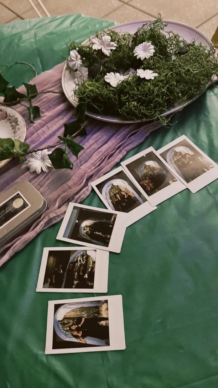 Polaroid photos laid out on a silk cloth from prom