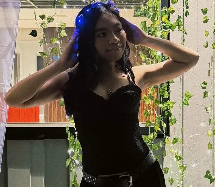 Audrey posing with her hands in her hair at prom