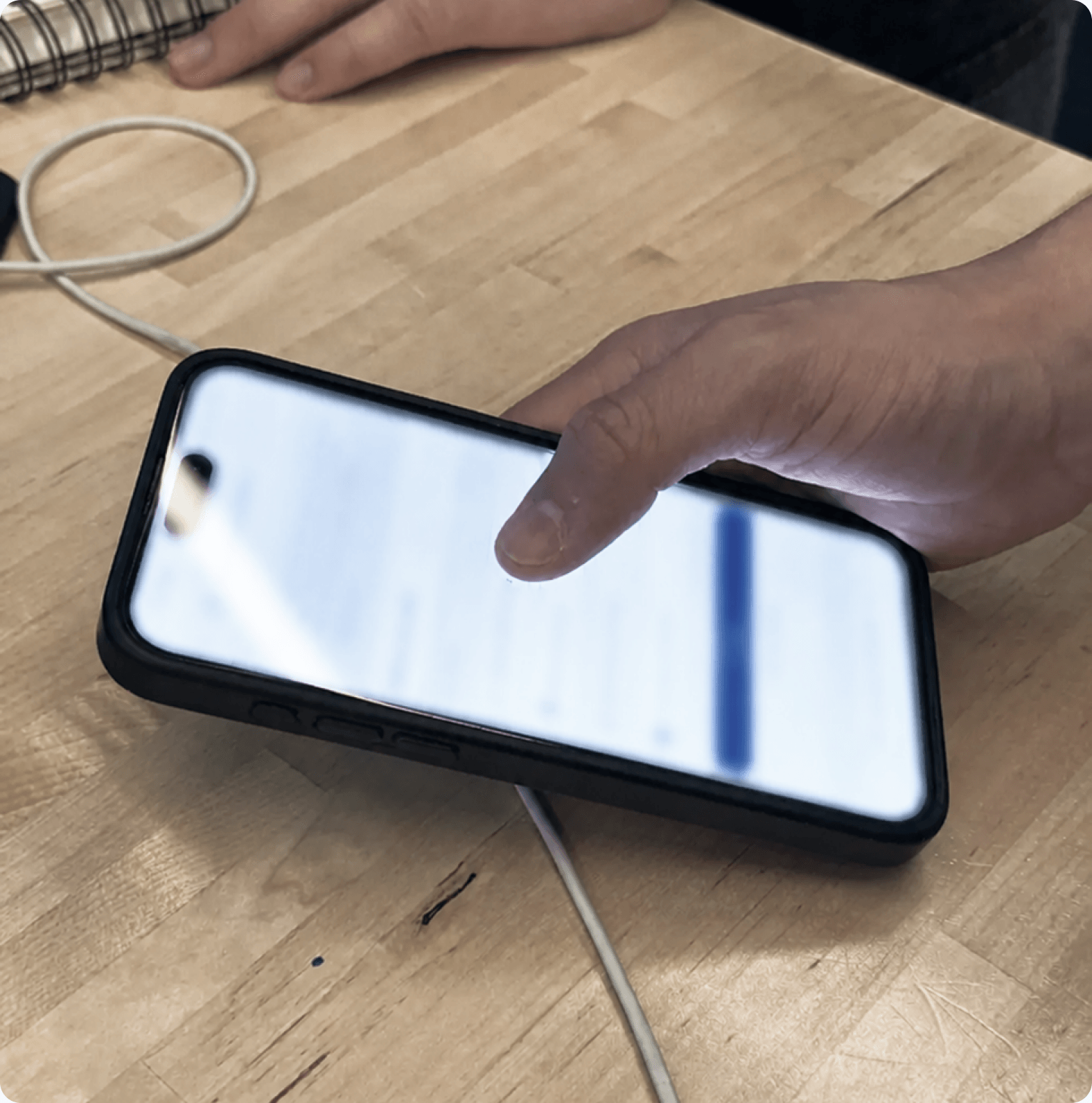 Participant testing the prototype on a phone during a usability session