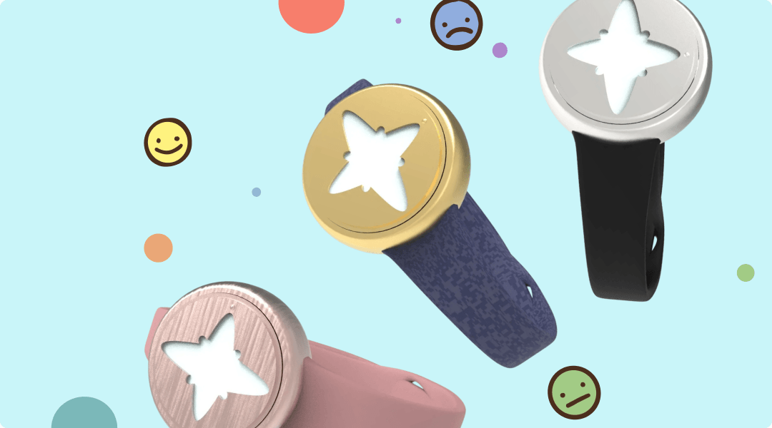 Three Emora bracelet colorways in gold with a navy band, silver with a black band, and rose gold with a pink band, each with a star-shaped light window, surrounded by smiling, sad, and neutral face icons